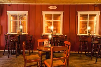 Inside Den Danske Kro, Danska Kráin in Reykjavík Iceland, with warm lights lighting up the seating area.